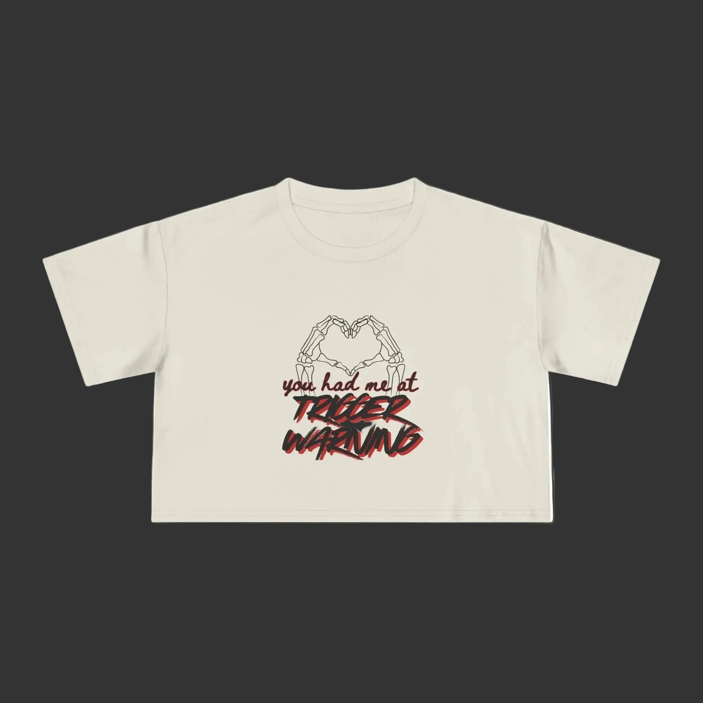 Bone crop top with graphic design and text on a grey background